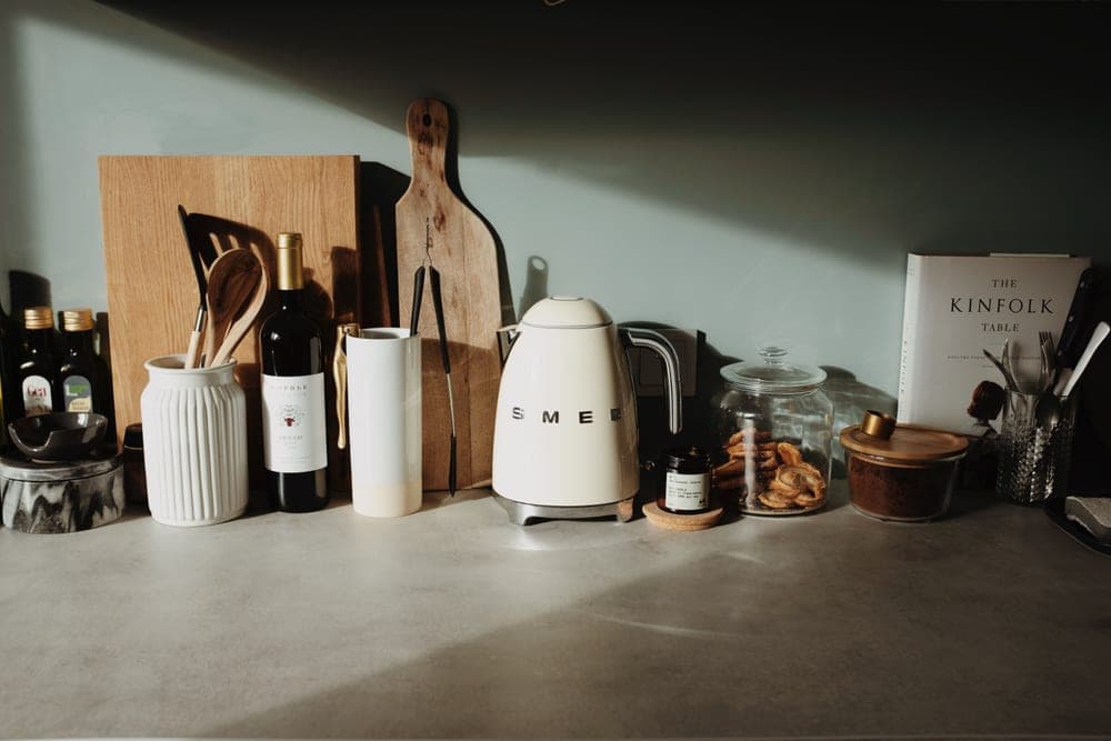 A kettle being cleaned with vinegar on a counter