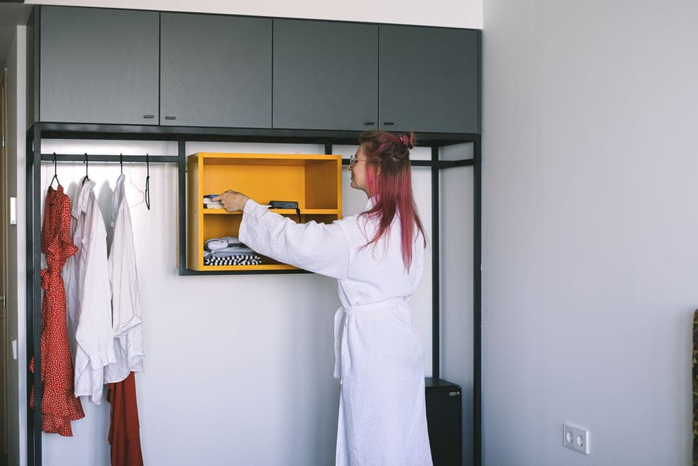A garment hanging on a rail in a hotel room