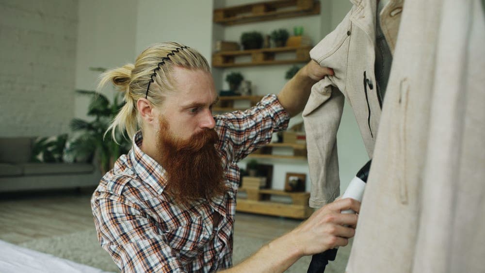 A person steaming a shirt at home