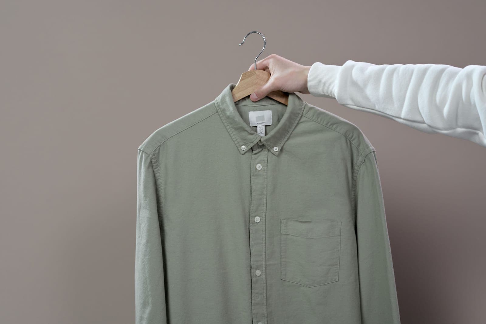 A crumpled shirt on a hanger