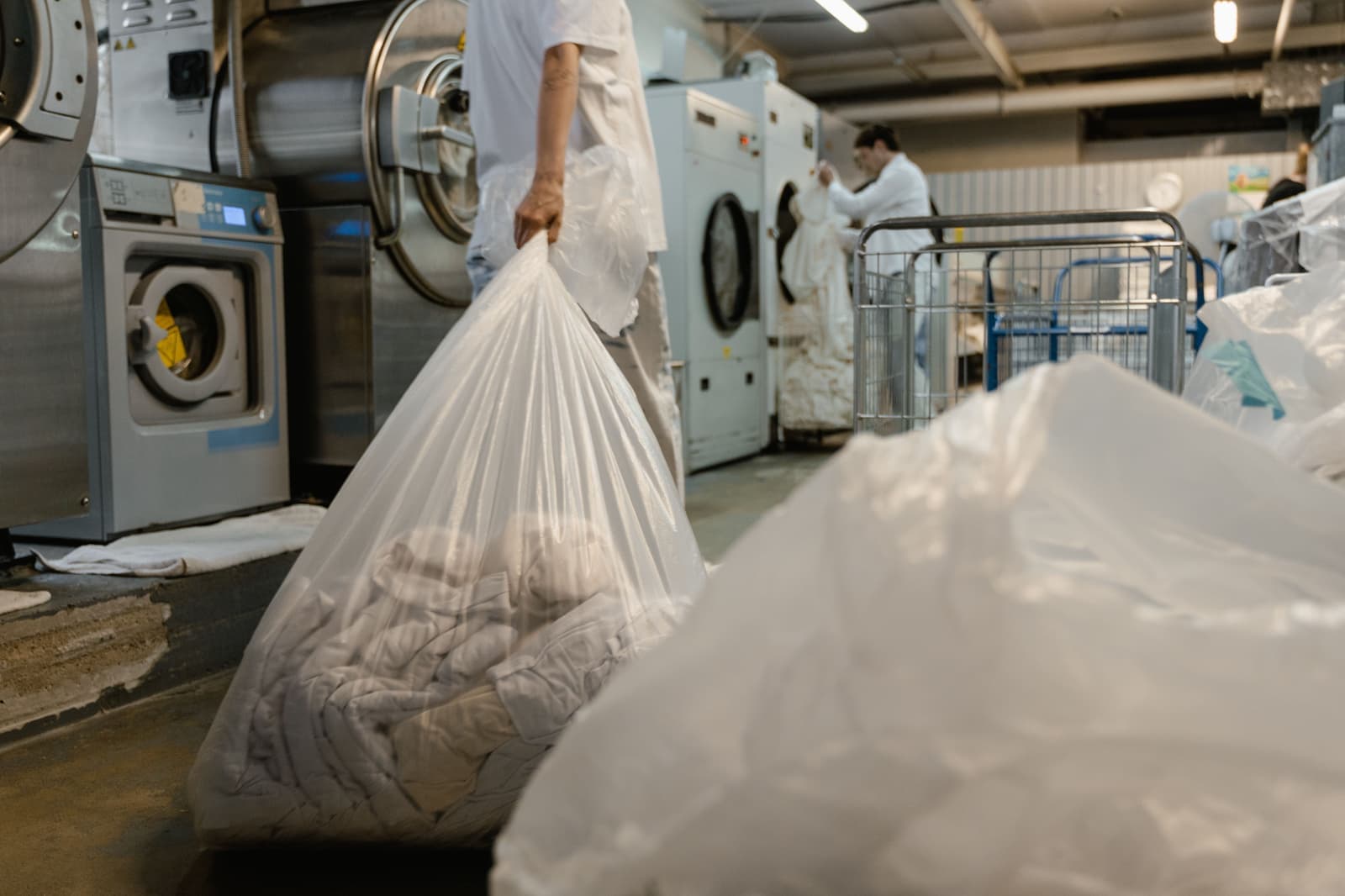 Garments in dry cleaning bags on a rail