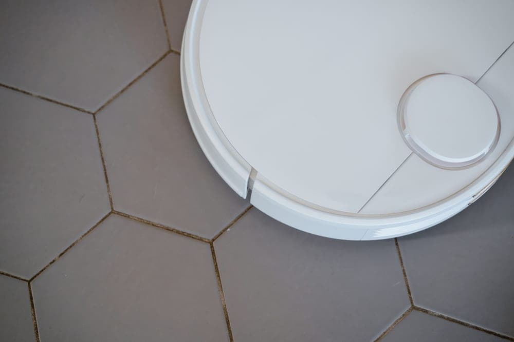 A steam cleaner being used on a hard floor