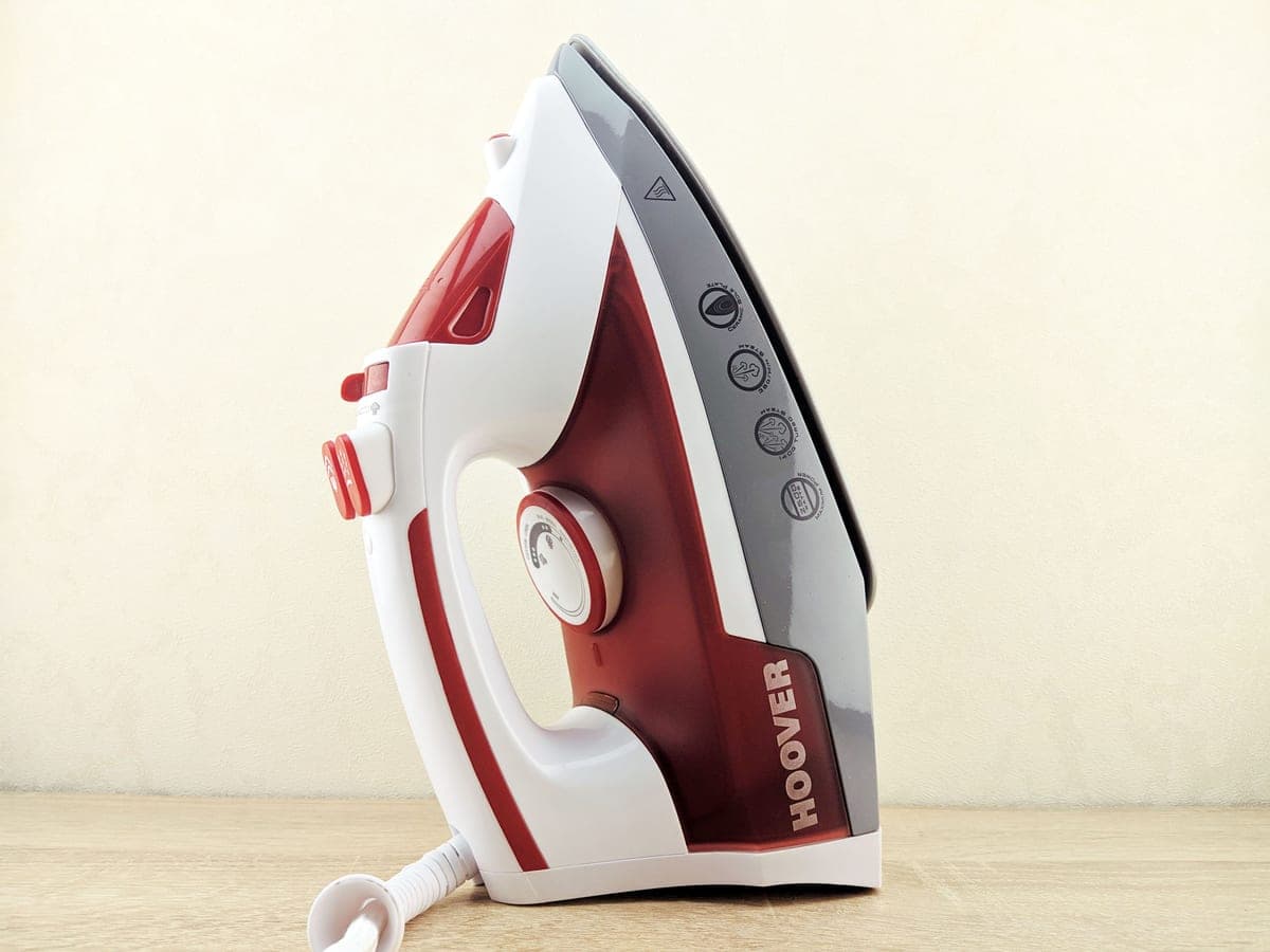 A clothes steamer and an iron side by side