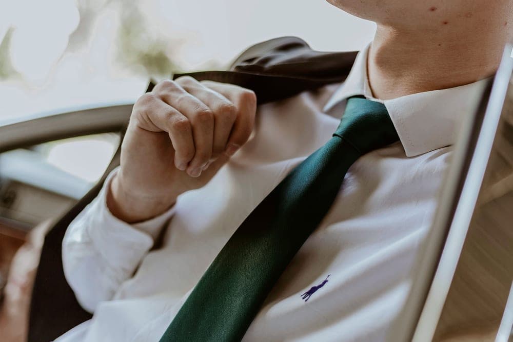 The collar of a crisp white dress shirt