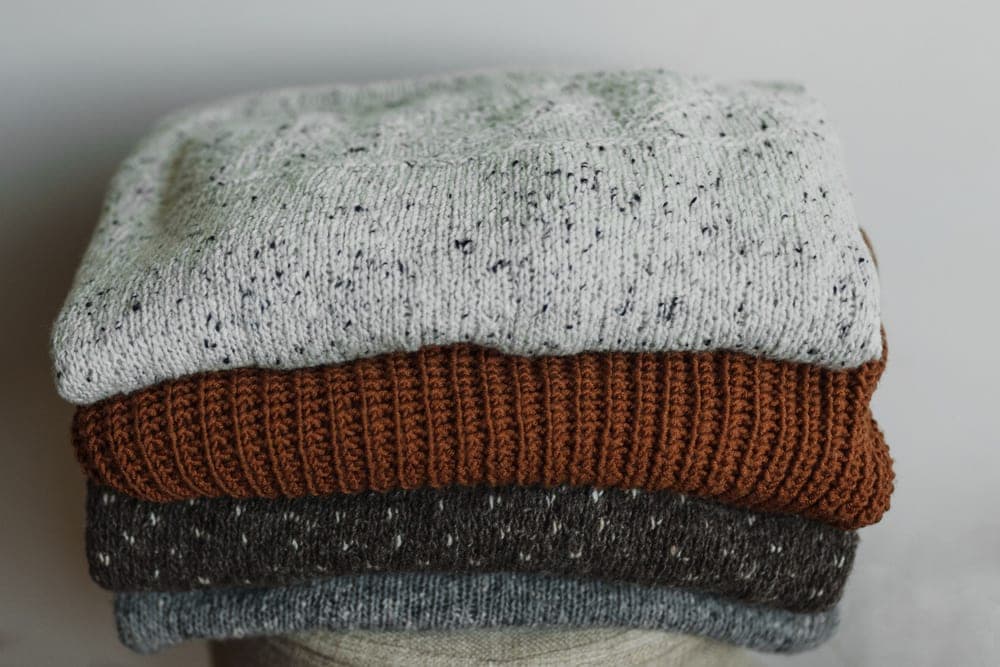 A folded knitted sweater in natural light