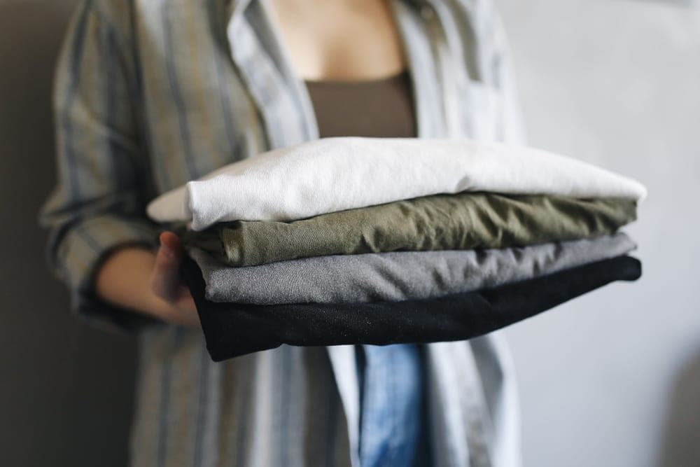 A folded stack of cotton shirts