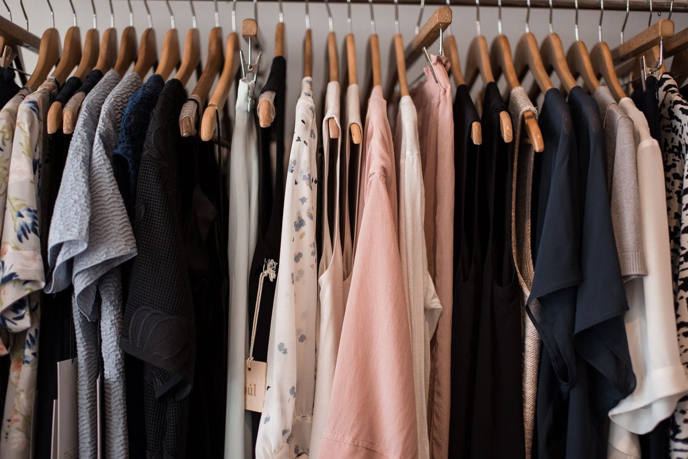 A rail of pressed shirts hanging in a wardrobe