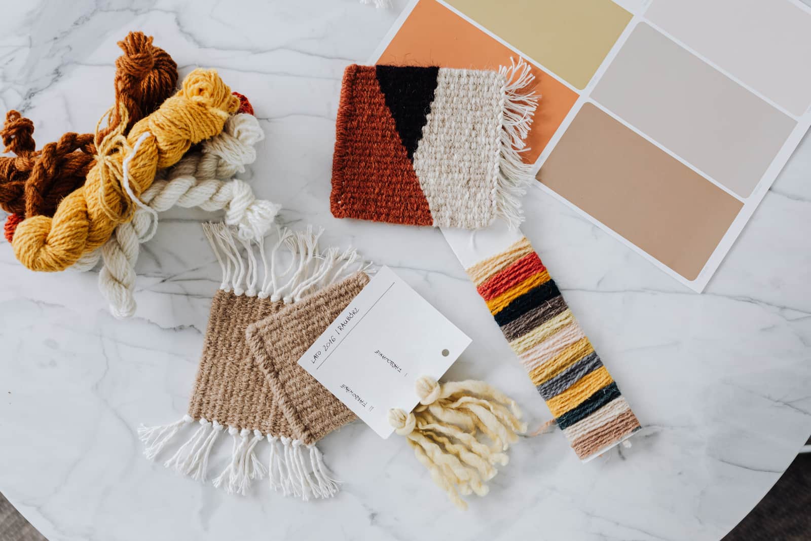 A hand-knitted wool swatch laid flat on a table