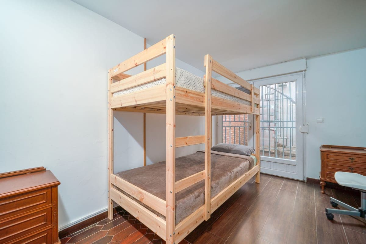 A small room with a compact clothes rail and folded laundry