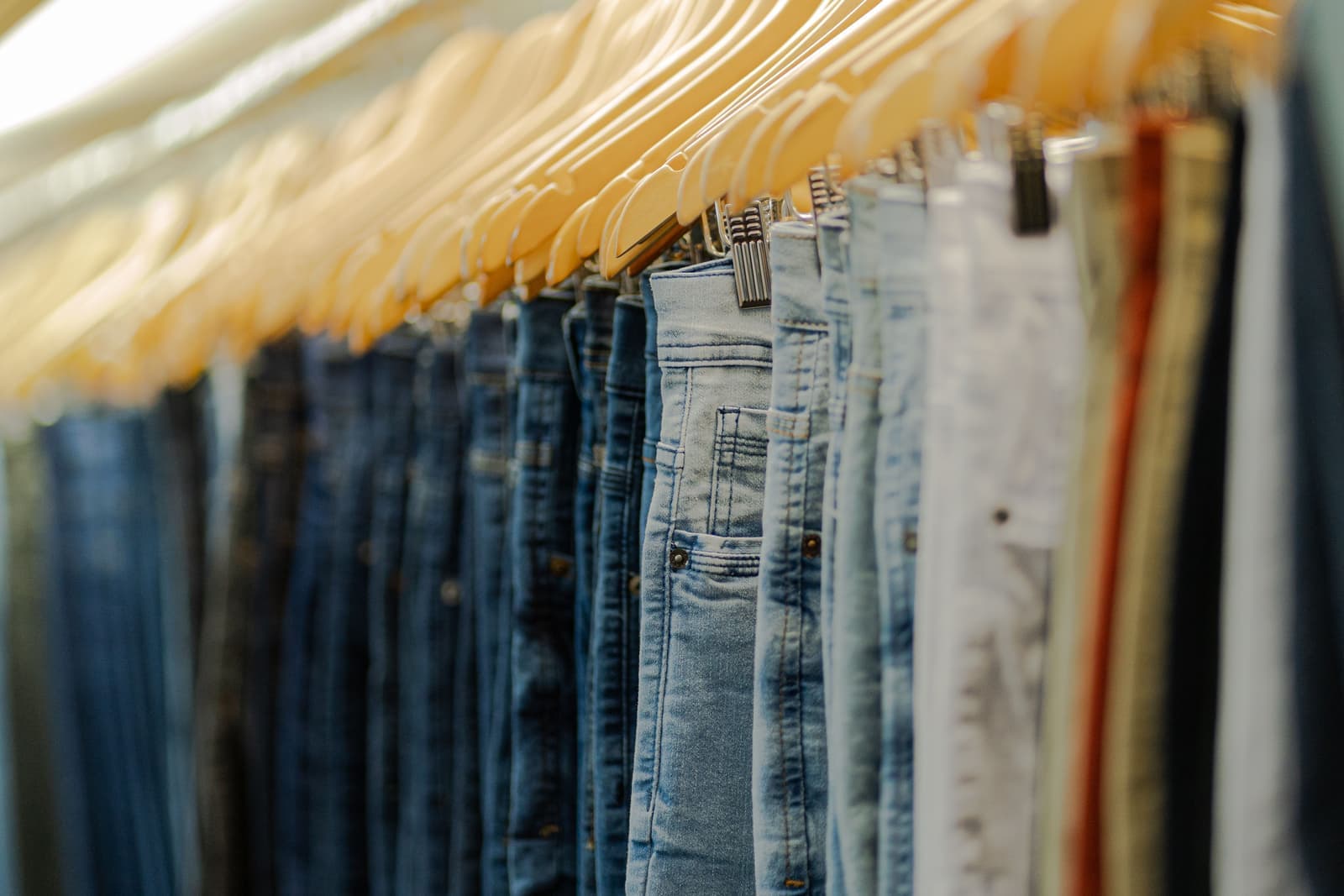 Folded trousers on a wooden hanger