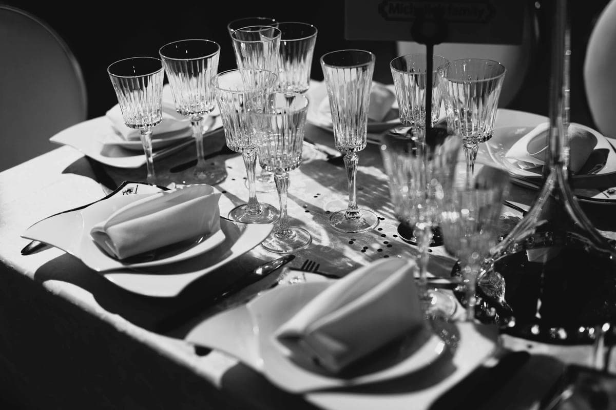 A white tablecloth on a set dining table