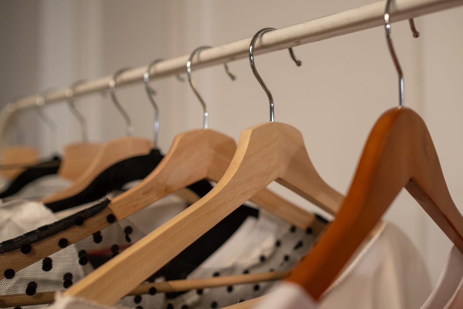 Tailored clothing hanging on a rail in a quiet room